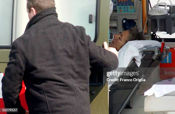 Freed Italian hostage Giuliana Sgrena is escorted to an ambulance on a stretcher at Ciampino airport a day after she was rescued from her Iraqi...