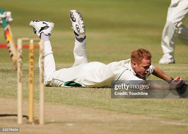 Shaun Pollock of South Africa dives to take a catch during day two of the first test against Zimbabwe at Newlands March 5, 2005 in Cape Town, South...