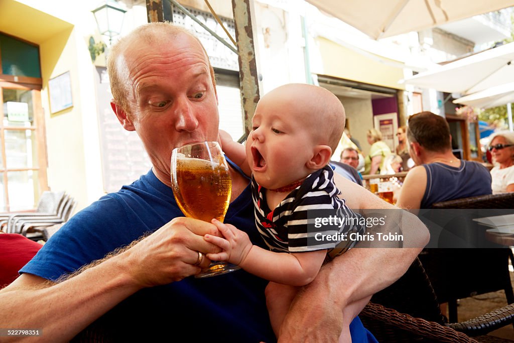 Baby trying to drink beer