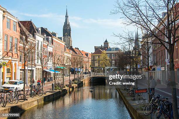 delft bike route along city canal in spring - delft stock pictures, royalty-free photos & images