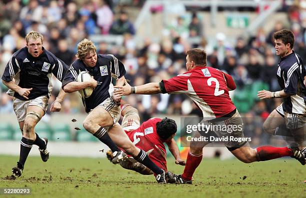 Ollie Smith of The North Team evades the tackle from John Smit of The South Team during the IRB Rugby Aid Match between The Northern Hemisphere and...