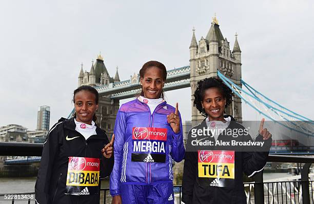 Elite women competitors Mare Dibaba, Aselefech Mergia and Tigist Tufa of Ethiopia pose in front of Tower Bridge as they attend a photocall ahead of...