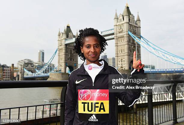 Elite women 2015 race winner Tigist Tufa of Ethiopia poses in front of Tower Bridge as they attend a photocall ahead of the Virgin Money London...