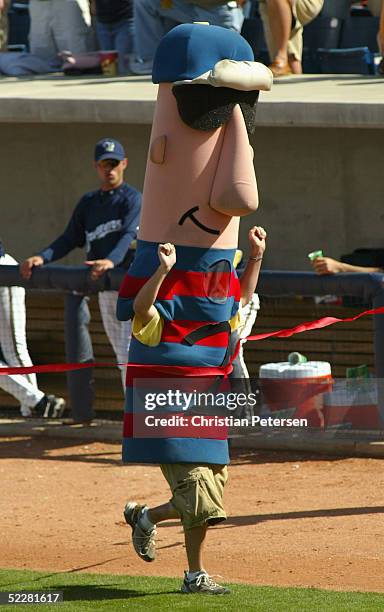 Fans compete in the sausage race during a break from action at the MLB spring training game between the Oakland Athletics and the Milwaukee Brewers...