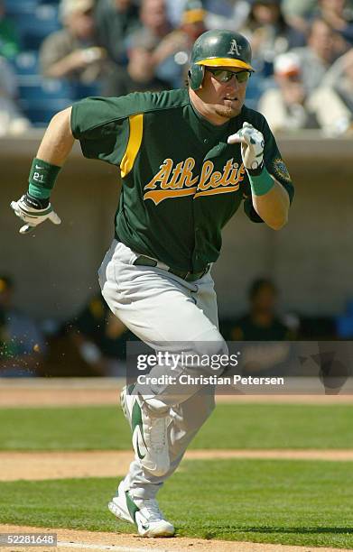 Mark Kotsay of the Oakland Athletics runs to first base during the MLB spring training game against the Milwaukee Brewers at Maryvale Baseball Park...