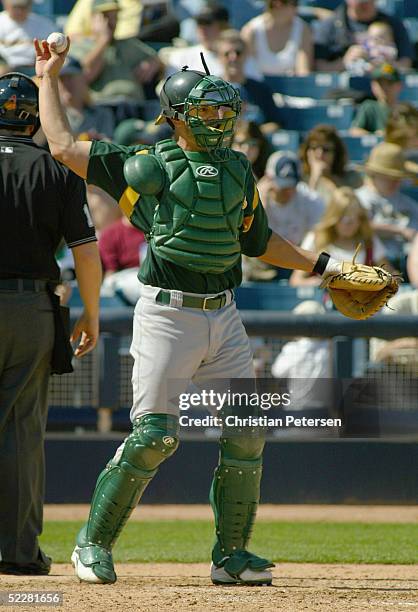 Jason Kendall of the Oakland Athletics throws the ball to the pitcher during the MLB spring training game against the Milwaukee Brewers at Maryvale...