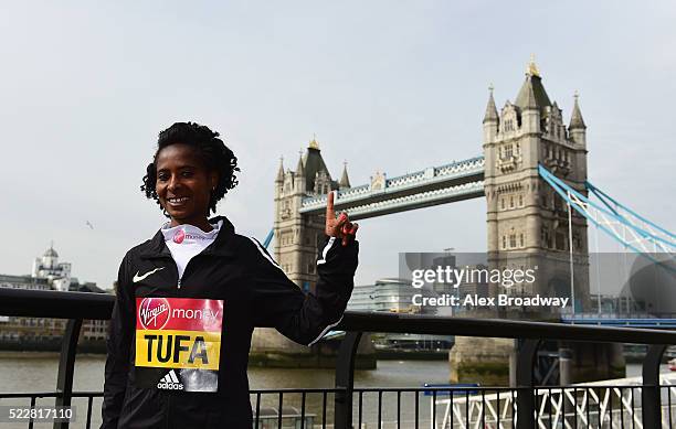 Elite women 2015 race winner Tigist Tufa of Ethiopia poses in front of Tower Bridge as they attend a photocall ahead of the Virgin Money London...