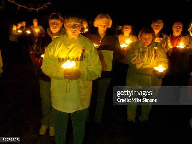 Josh Bryant , brother of Jessica Marie Lunsford, takes part in a candlelight vigil March 5, 2005 in Roachester, Ohio. Lunsford's mom and much of her...