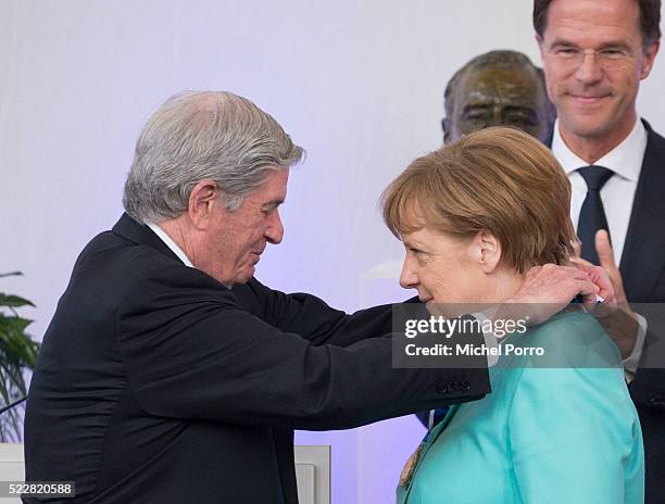 German Chancellor Angela Merkel receives the Four Freedoms Award from Elliott Roosevelt while Dutch Prime Minister Mark Rutte looks on during the...