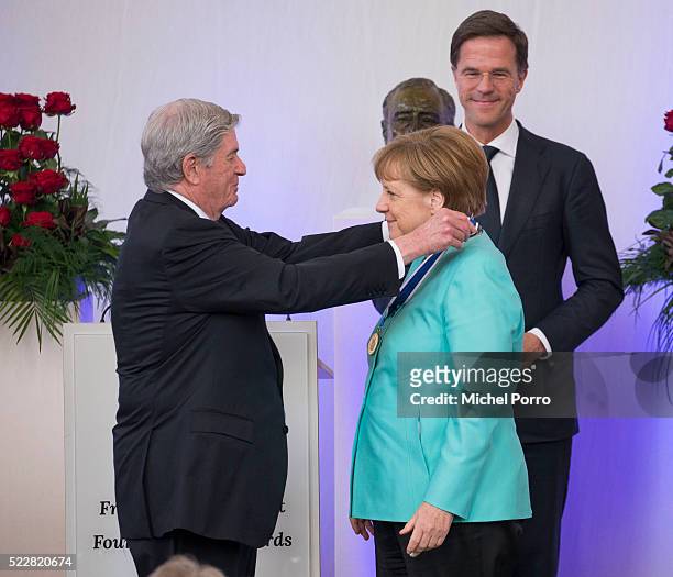 German Chancellor Angela Merkel receives the Four Freedoms Award from Elliott Roosevelt while Dutch Prime Minister Mark Rutte looks on during the...