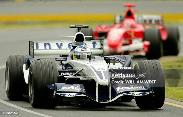 Germany's Nick Heidfeld in a Williams-BMW attempts to hold of the challenge of compatriot Michael Schumacher in a Ferrari shortly before they collide...