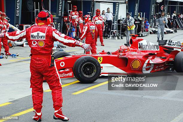 Ferrari Formula One driver Michael Schumacher of Germany drives into his garage after retiring from the Australian Grand Prix at Melbourne's Albert...