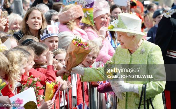 Britain's Queen Elizabeth II greets wellwishers during a 'walkabout' on her 90th birthday in Windsor, west of London, on April 21, 2016. Britain...