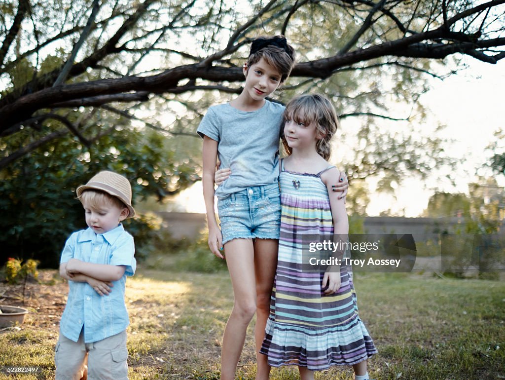 Children outdoors casually looking at camera