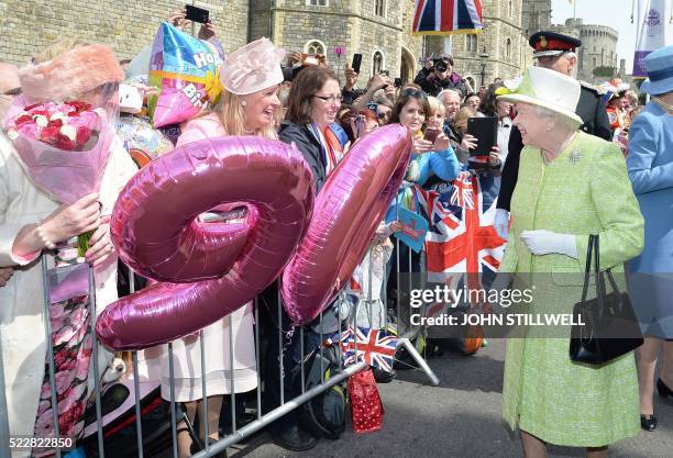 Britain's Queen Elizabeth II greets wellwishers during a 'walkabout' on her 90th birthday in Windsor, west of London, on April 21, 2016. Britain...