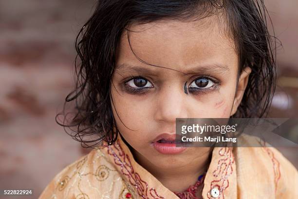 Child with khol in the streets of Calcutta, West Bengal, India. Khol or Indian kajal was originally used as protection against eye ailments. There...