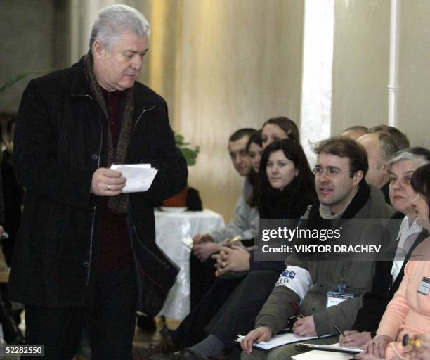 Moldovan President Vladimir Voronin passes by Organization for Security and Coooperation in Europe observers as he gets ready to cast his ballot at a...