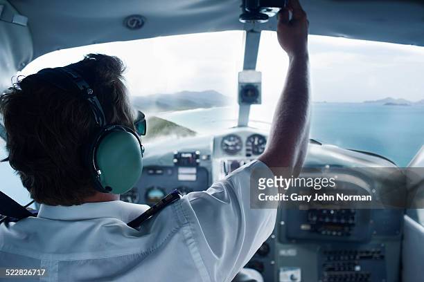 pilot in cockpit of seaplane - propellermaschine stock-fotos und bilder