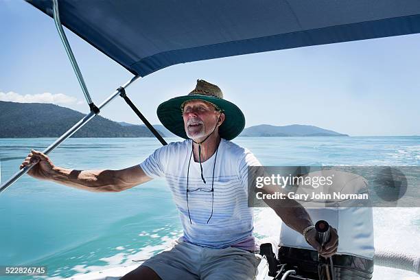 man steering motor boat or tinnie. - motor boat photos et images de collection