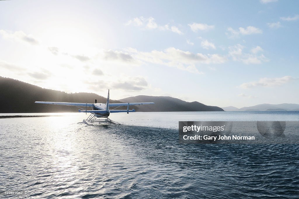 Seaplane leaving island.