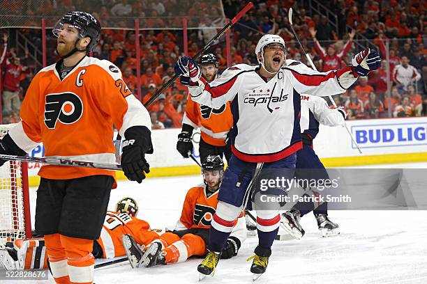 Alex Ovechkin of the Washington Capitals reacts in front of Claude Giroux of the Philadelphia Flyers after teammate T.J. Oshie of the Washington...