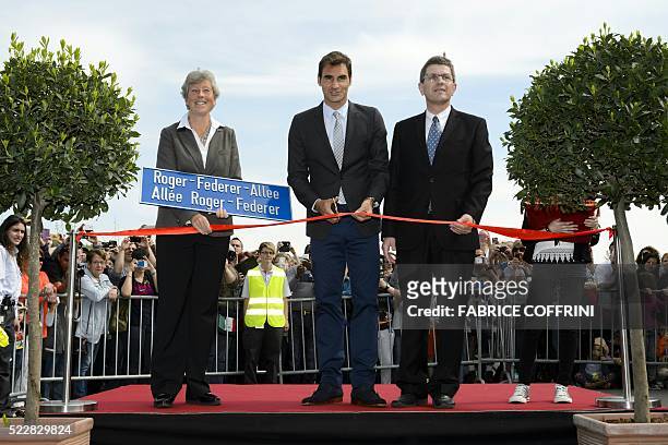 Swiss tennis champion Roger Federer takes part in the ceremony marking the inauguration of a street bearing his name next to Mayor of the city of...