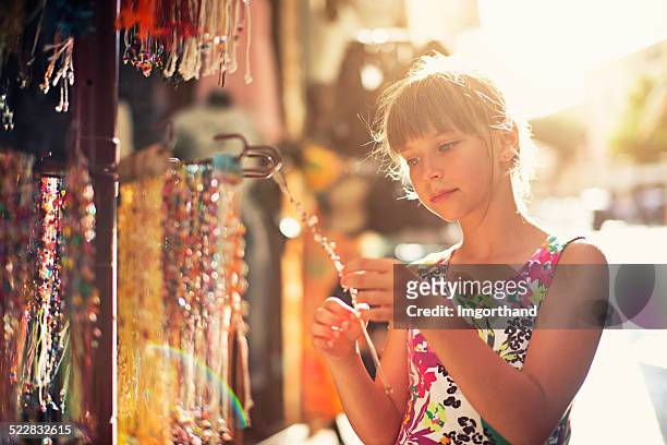 browsing street jewelry stand - girl who stands stock pictures, royalty-free photos & images