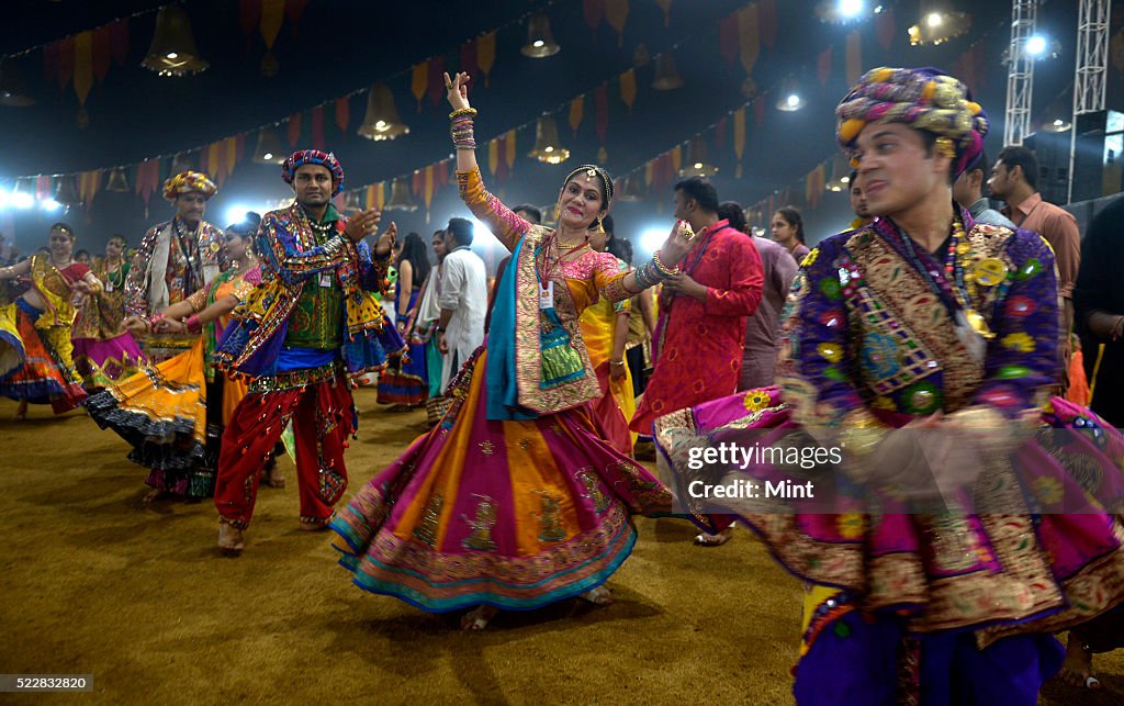 People Enjoying Garba Dance In Colorful Traditional Gujrati Dresses people-enjoying-garba-dance-in-colorful-traditional-gujrati-dresses