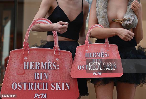 Models, Edita Stasiuleviciute from Lithuania and Katie Doherty from Co.Kerry, covered by an ostrich &quot;corpse&quot; and carrying an handbag-shaped...