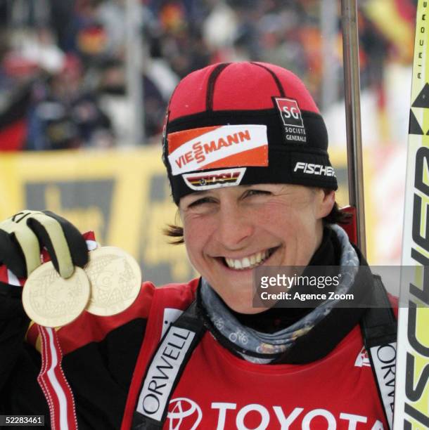 Uschi Disl of Germany celebrates with her two gold medals after the Women's 10km Pursuit in the Biathlon World Cup event March 6, 2005 in Hochfilzen,...