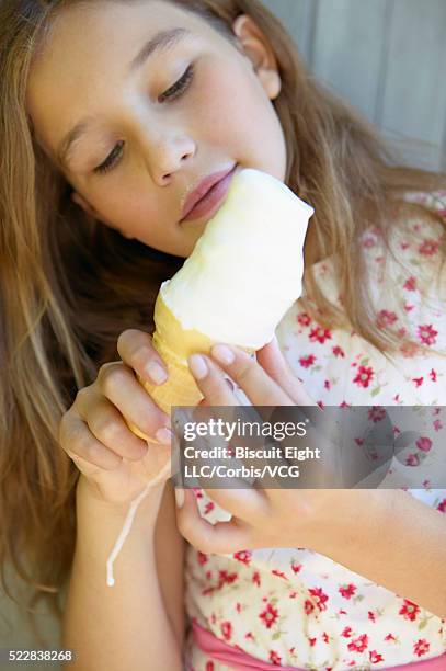 girl eating ice cream cone - girl eating messy ice cream cone stock-fotos und bilder