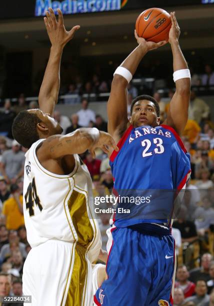 Wayne Simien of the Kansas Jayhawks takes a shot as Kalen Grimes of the Missouri Tigers defends on March 6, 2005 at Mizzou Arena in Columbia,...