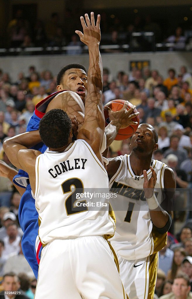 Jason Conley Wayne Simien of Kansas tries to shoot around Jason Conley and Jimmy ...