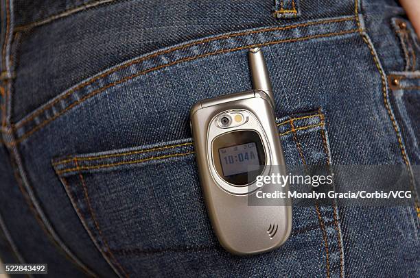 cell phone in back pocket of woman's jeans - phone in back pocket stock pictures, royalty-free photos & images