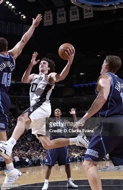 Emanuel Ginobili of the San Antonio Spurs shoots over Kris Humphries of the Utah Jazz at the SBC Center on March 6, 2005 in San Antonio, Texas. NOTE...
