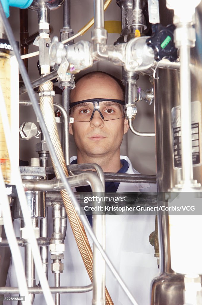 Scientist with complex machinery