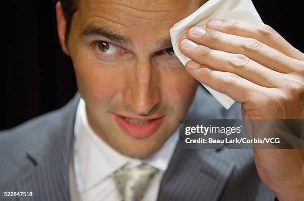 businessman wiping forhead with handkerchief - forehead stock pictures, royalty-free photos & images
