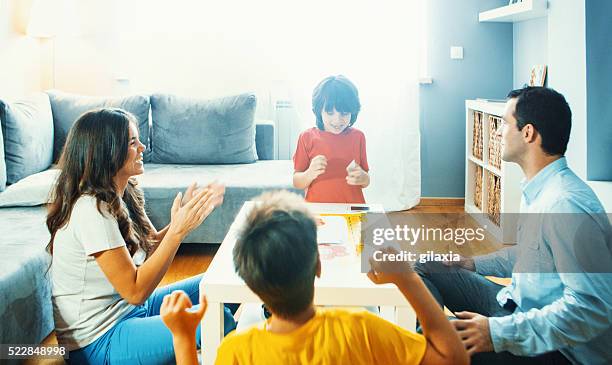 family playing board game at home. - board game stock pictures, royalty-free photos & images