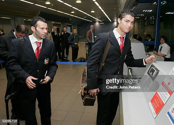 Ryan Giggs and Cristiano Ronaldo of Manchester United check in at Manchester Airport prior to flying out to Milan for their UEFA Champions League...