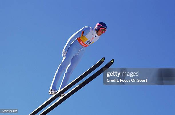 Skier flies through the air as he competes in the 90m team jump during the Winter Olympics circa Febuary, 1988 in Calgary, Canada.