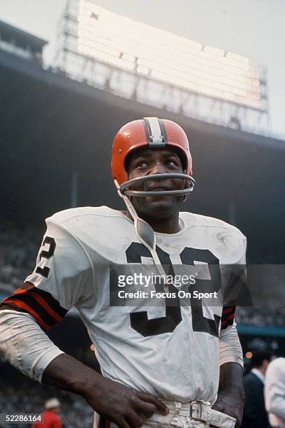 American football player, running back Jim Brown, #32 of the Cleveland Browns, stands on the field during a game. Jim Brown played for the Browns...