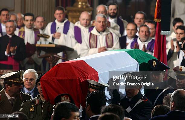 The coffin of killed Italian intelligence officer Nicola Calipari is carried through Santa Maria Degli Angeli Basilica during the State funeral on...