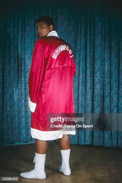 Muhammad Ali poses a portrait in his robe in 1964.