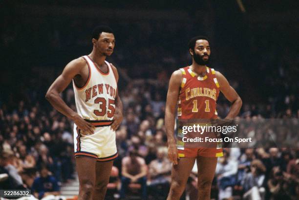 Cleveland Cavaliers' guard Walt Frazier looks on as he stands next to a New York Knicks player during a game circa 1978-1980.