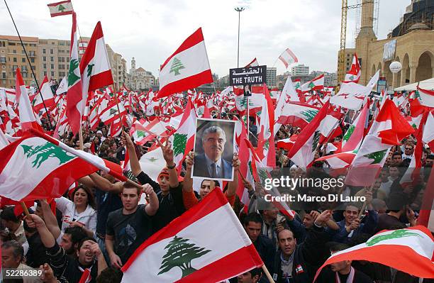 Lebanese demonstrator holds a portrait of slain former Lebanese Former Prime minister Rafik Hariri during an anti-Syrian demonstration in Martyr...