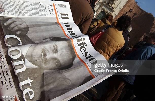 The Italian journal Il Manifesto displays Italian intelligence officer Nicola Calipari on the front cover outside Santa Maria Degli Angeli Basilica...