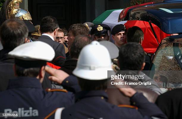 The coffin of killed Italian intelligence officer Nicola Calipari leaves Santa Maria Degli Angeli Basilica during the State funeral on March 7, 2005...