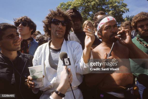 American political activist Abbott "Abbie" Hoffman speaks to a journalist from the midst of a crowd of demonstators gathered in protest of the...