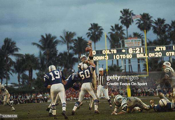 Quarterback Johnny Unitas of the Baltimore Colts throws a pass as a New York Jets linebacker goes up in an attempt to block the pass during Super...