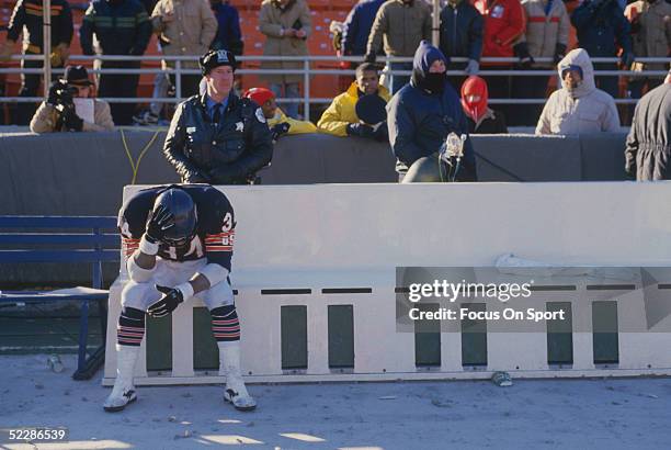 Chicago Bears' running back Walter Payton sits alone in a bench on the sidelines during a game circa 1975-1987.